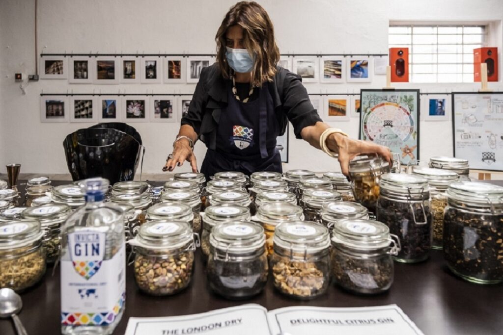 A Gin School student selecting from a range of botanicals to add to her gin